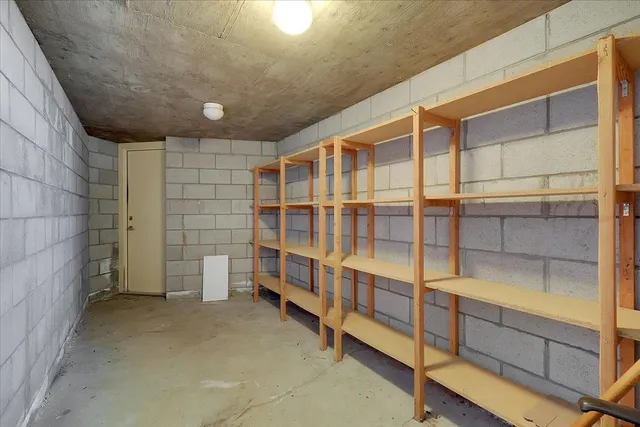 a bathroom with a granite countertop toilet sink and mirror