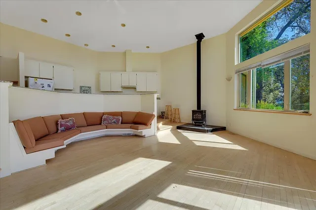 a living room with furniture and large windows