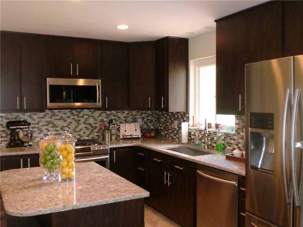290 Manor Road Wexford, PA 15090 - Photo 2 of 25 The Kitchen's dark cabinets are complimented by the lighter granite countertops, backsplash, stainless appliances and recessed lighting!
