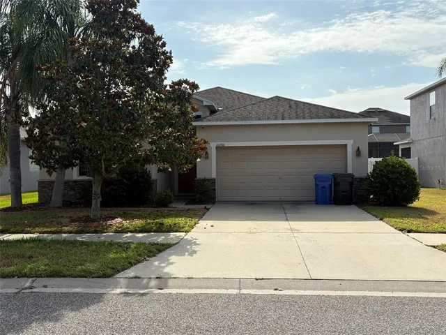 a front view of a house with a yard and garage