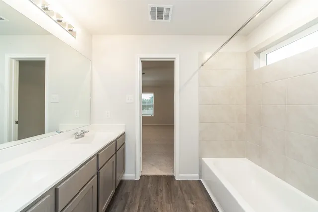 a bathroom with a bathtub and a sink
