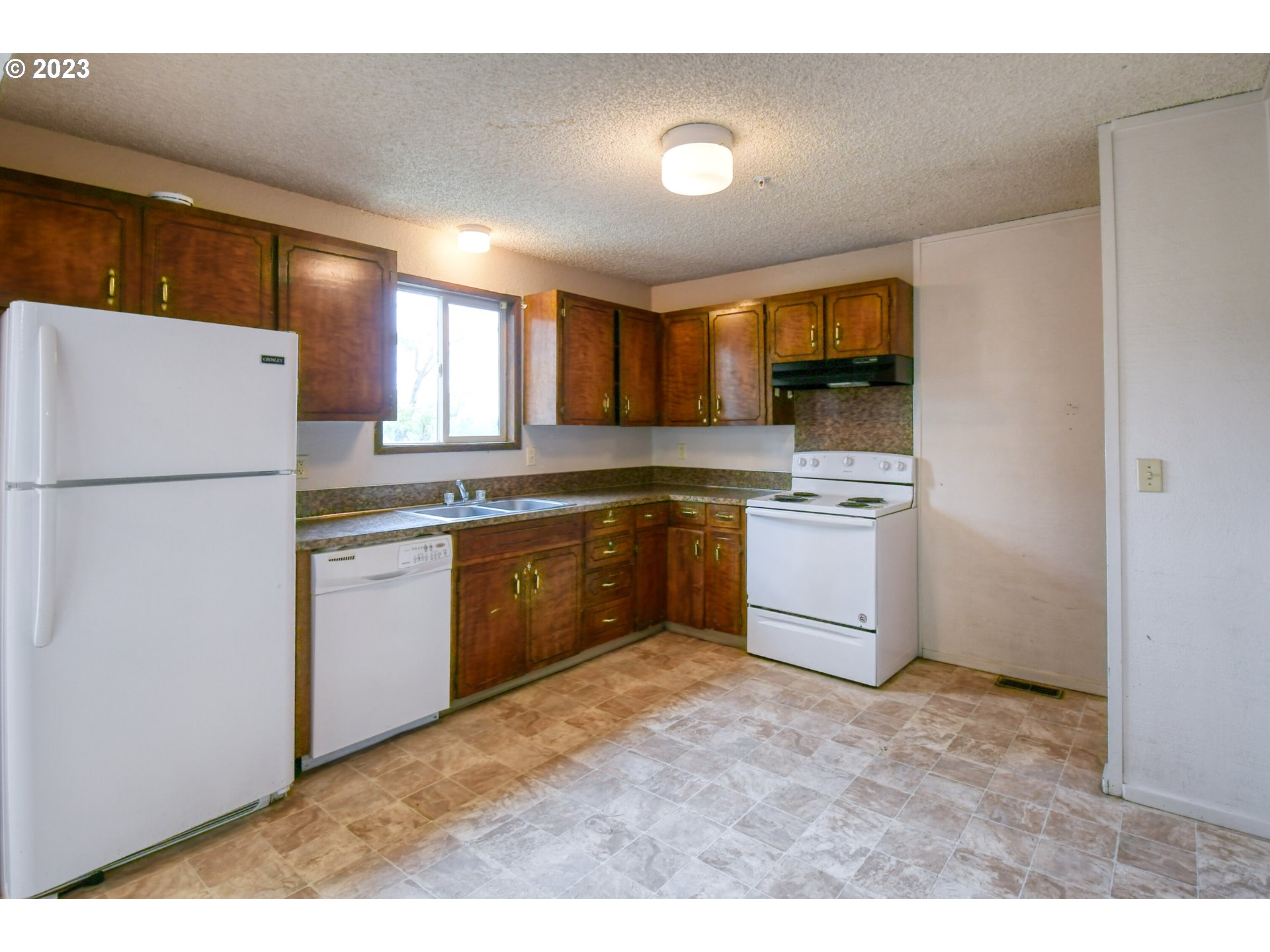 821 Southwest 2nd Street Pendleton, OR 97801 - Photo 8 of 48 a kitchen with a white stove top oven and refrigerator