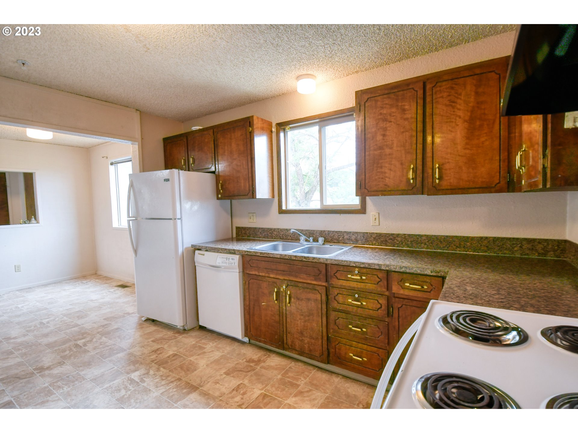 821 Southwest 2nd Street Pendleton, OR 97801 - Photo 9 of 48 a kitchen with a refrigerator and a stove top oven