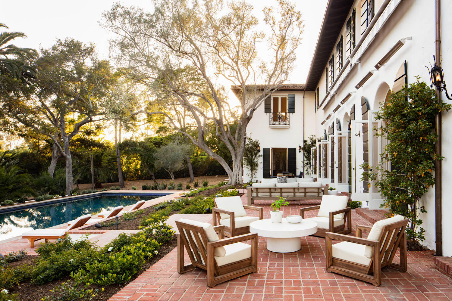 a view of a patio with couches chairs and a fire pit