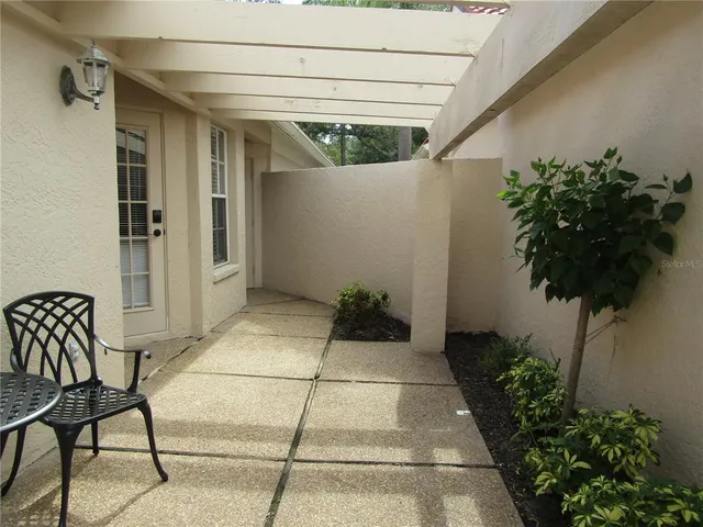 a view of a porch with potted plants