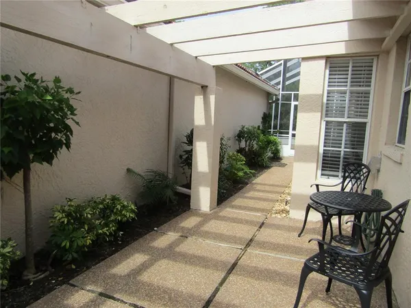 a view of a house with backyard and sitting area