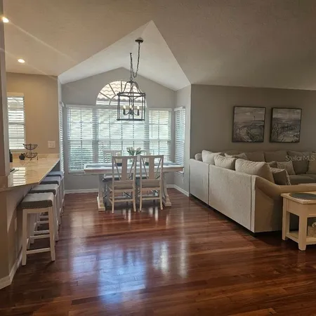 a view of a dining room with furniture window and wooden floor
