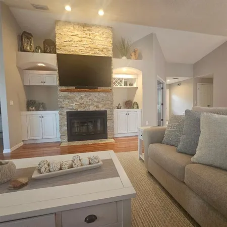 a living room with furniture and a fireplace