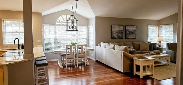 a living room with furniture dining table and a large window