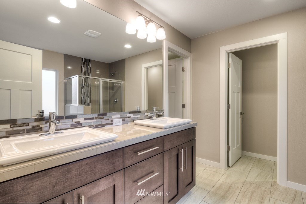 2125 228th Place Southwest, Unit EP12 Bothell, WA 98021 - Photo 13 of 16 a bathroom with a double vanity sink and a mirror