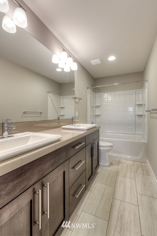 2125 228th Place Southwest, Unit EP12 Bothell, WA 98021 - Photo 15 of 16 a bathroom with a double vanity sink and a mirror