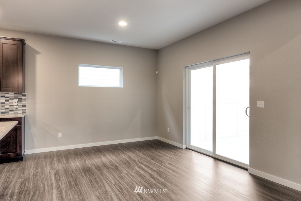2125 228th Place Southwest, Unit EP12 Bothell, WA 98021 - Photo 8 of 16 an empty room with wooden floor and a fireplace