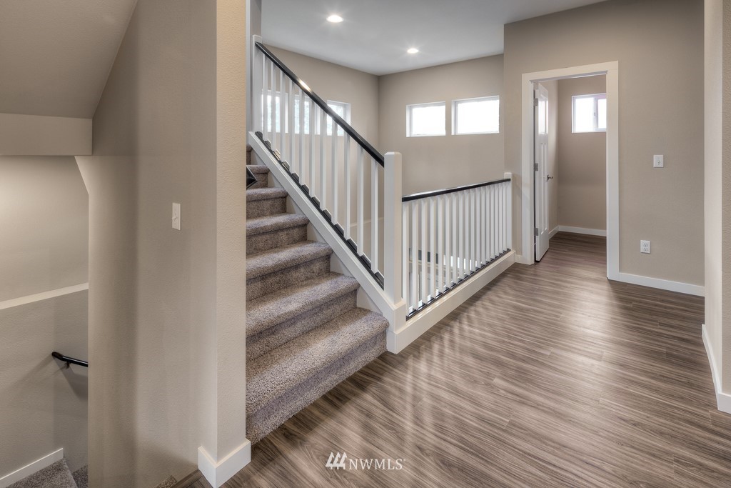 2125 228th Place Southwest, Unit EP12 Bothell, WA 98021 - Photo 9 of 16 a view of a hallway with wooden floor and entryway