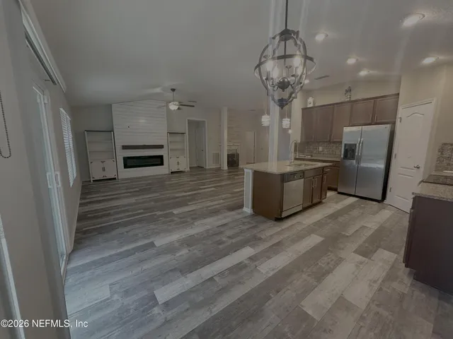 a bathroom with a sink and mirror with toilet