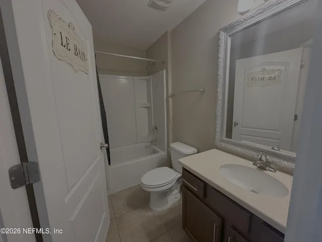 a bathroom with a sink a toilet a shower and a mirror