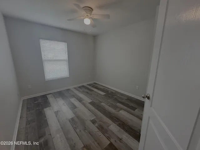 a view of hallway with wooden floor