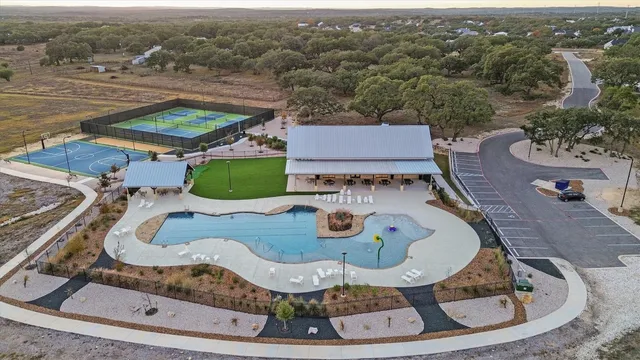 an aerial view of a house with garden space and pool view