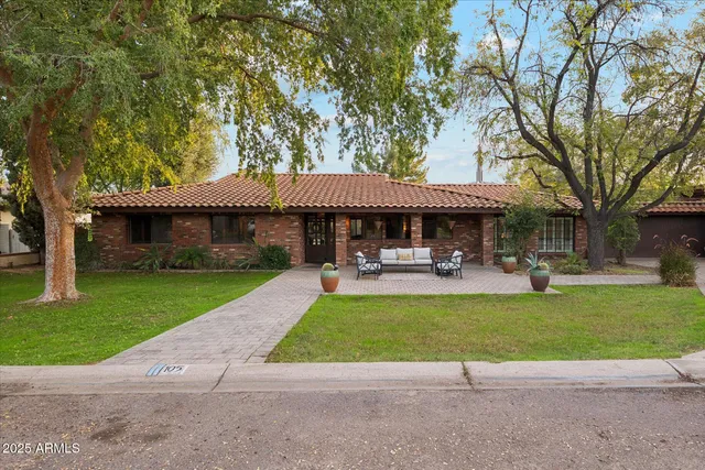 a view of a house with a yard porch and sitting area