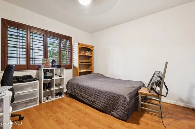 a bedroom with a bed and a window