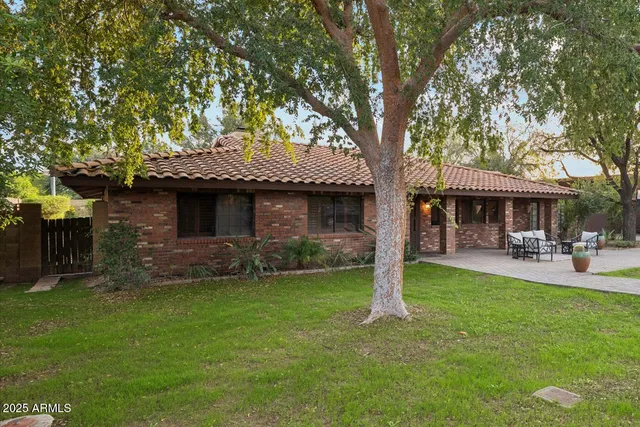 a front view of a house with a garden and patio