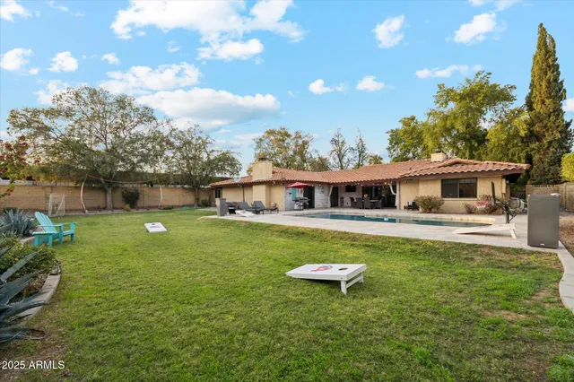 a front view of a house with a garden and sitting area