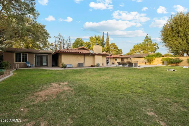 a front view of house with yard and lake view