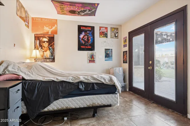 a bedroom with a bed and a painting on the wall