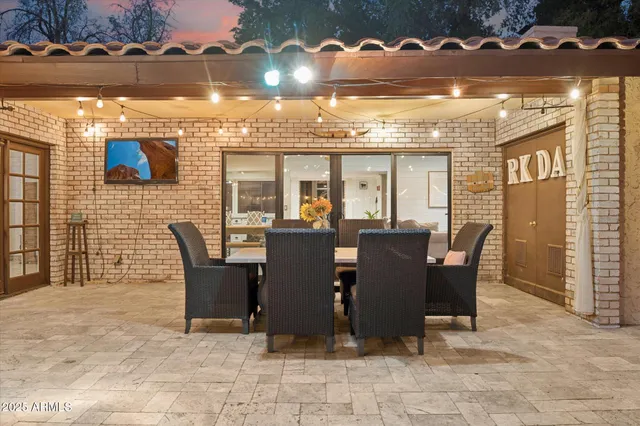 a view of a dining room with furniture and chandelier