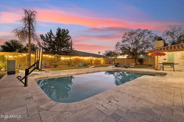 a view of a swimming pool with an outdoor seating