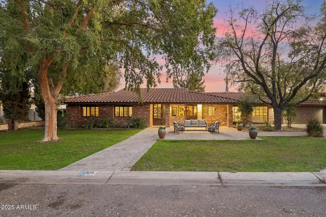 a view of a house with a yard and sitting area