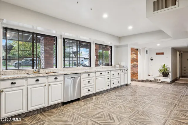a large bedroom with a large bed and large windows