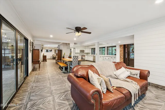 a living room with furniture ceiling fan and a rug