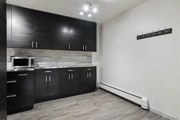 a kitchen with stainless steel appliances granite countertop cabinets and wooden floor