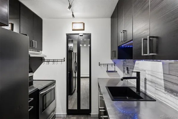 a kitchen with granite countertop a stove and a refrigerator