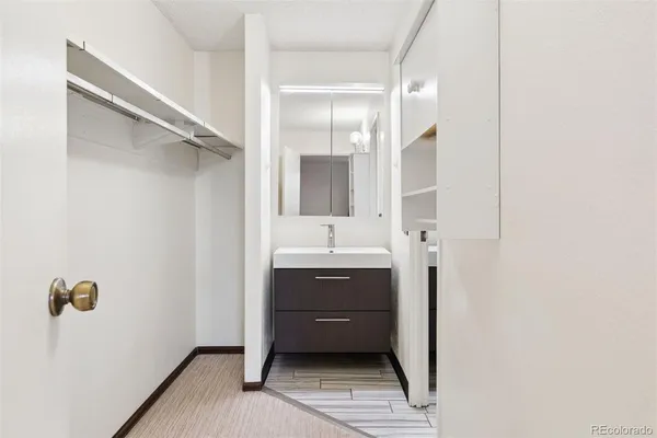 a bathroom with a sink a toilet and mirror