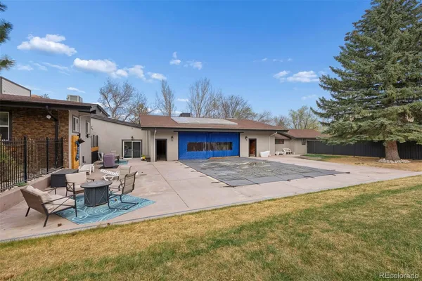 a view of a house with backyard and sitting area