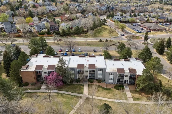 an aerial view of a house with swimming pool and lake view