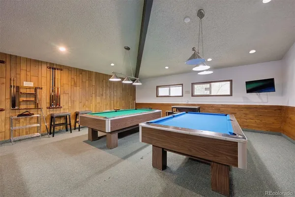 a room with pool table and windows