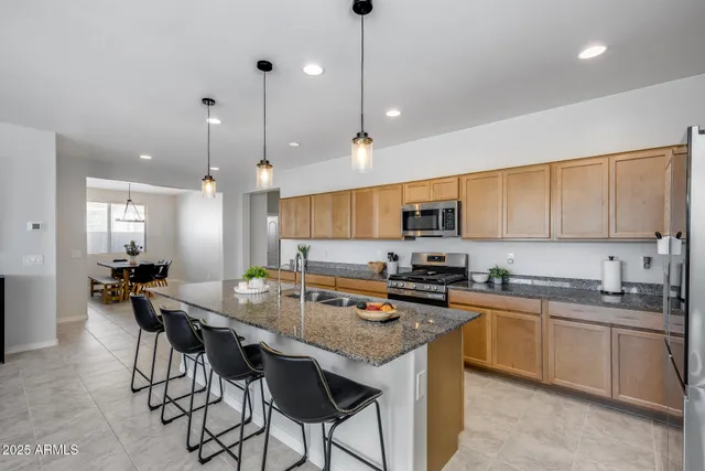 a kitchen with granite countertop lots of counter top space sink and appliances
