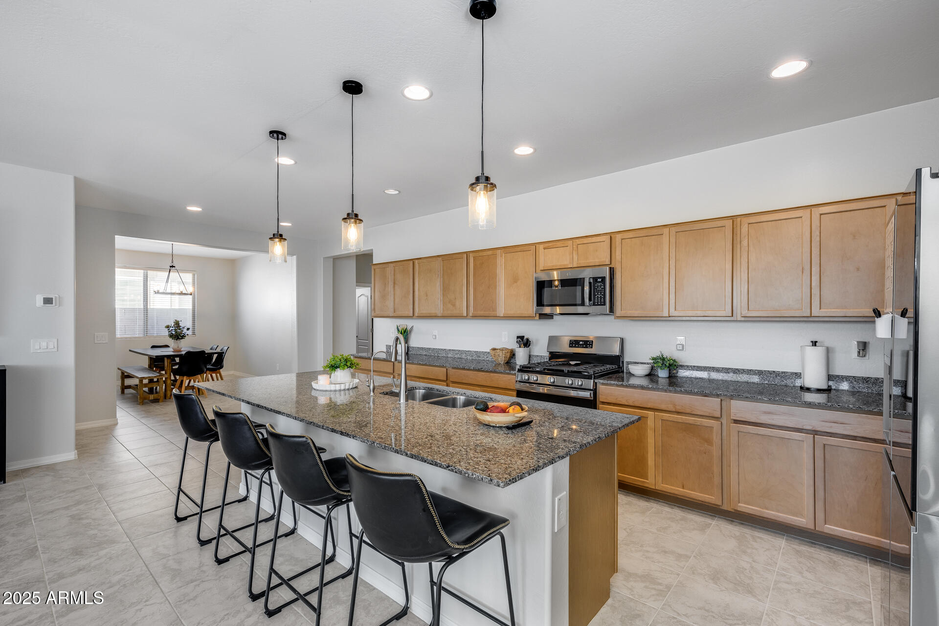 14866 West Sand Hills Road Surprise, AZ 85387 - Photo 21 of 54 a kitchen with granite countertop lots of counter top space sink and appliances