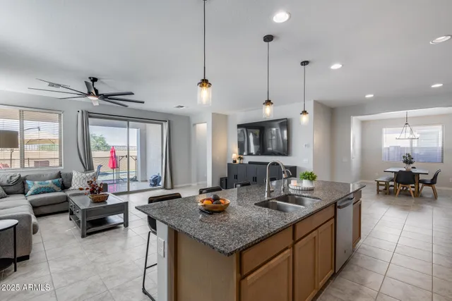 a kitchen with counter space appliances and a view of living room