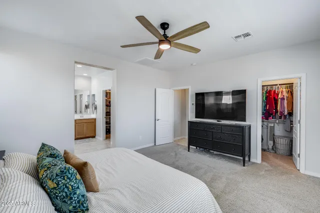 a bedroom with a bed and a television