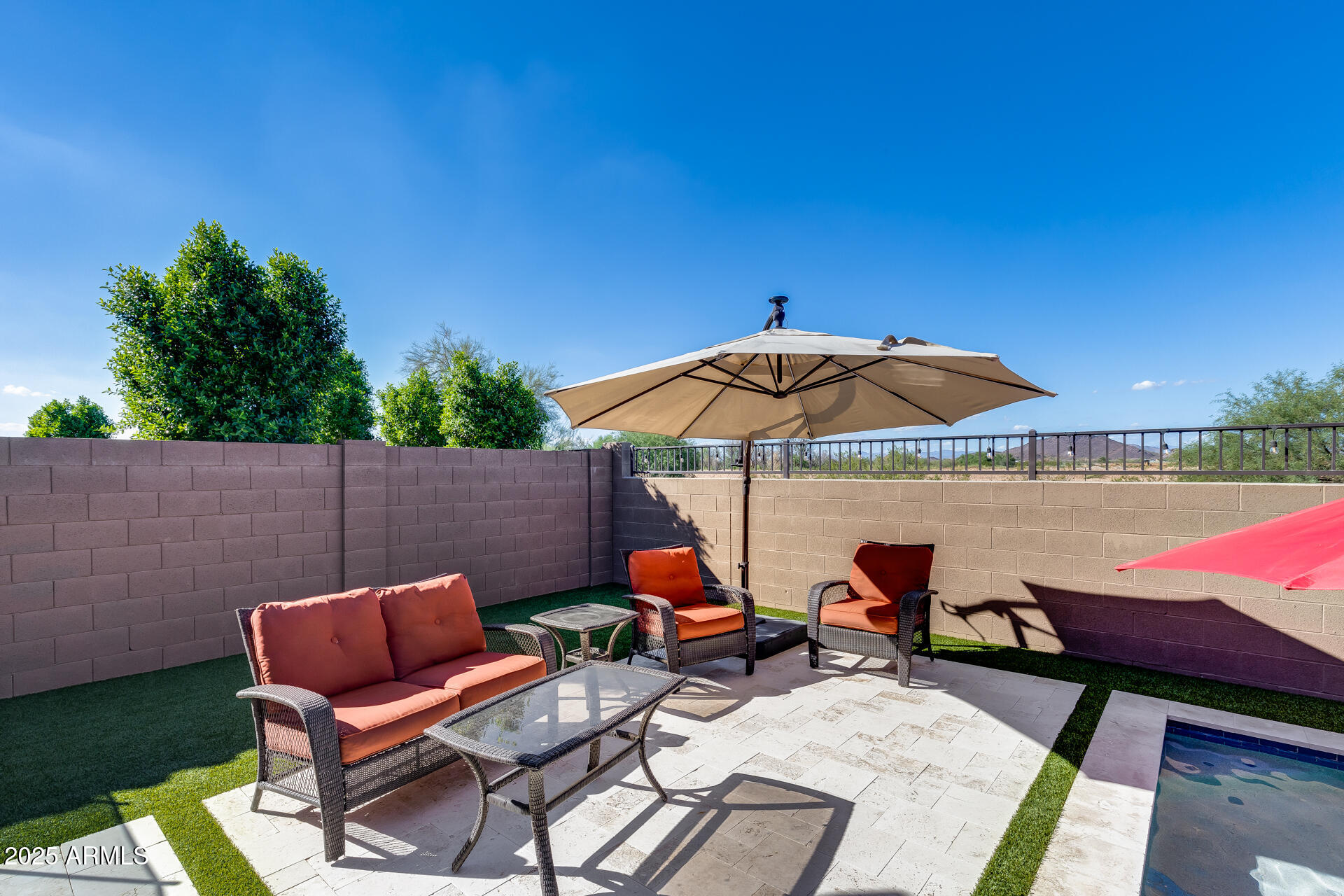 14866 West Sand Hills Road Surprise, AZ 85387 - Photo 38 of 54 an outdoor sitting area with furniture and umbrella