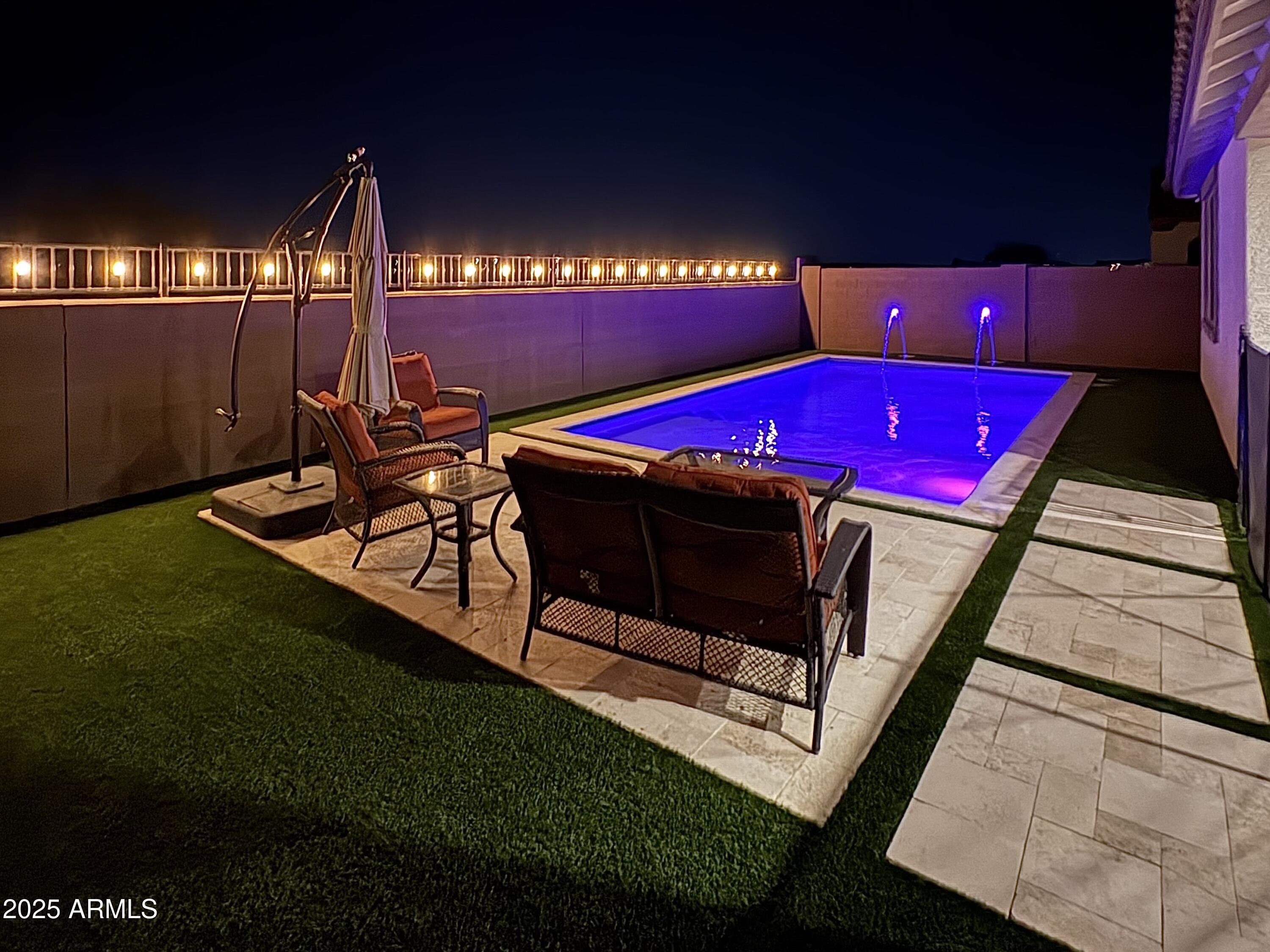 14866 West Sand Hills Road Surprise, AZ 85387 - Photo 41 of 54 a view of a chairs and fire pit in patio
