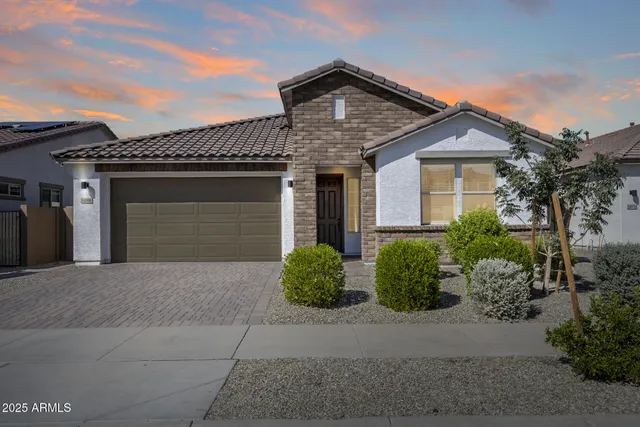 an aerial view of a house with a yard and lake view