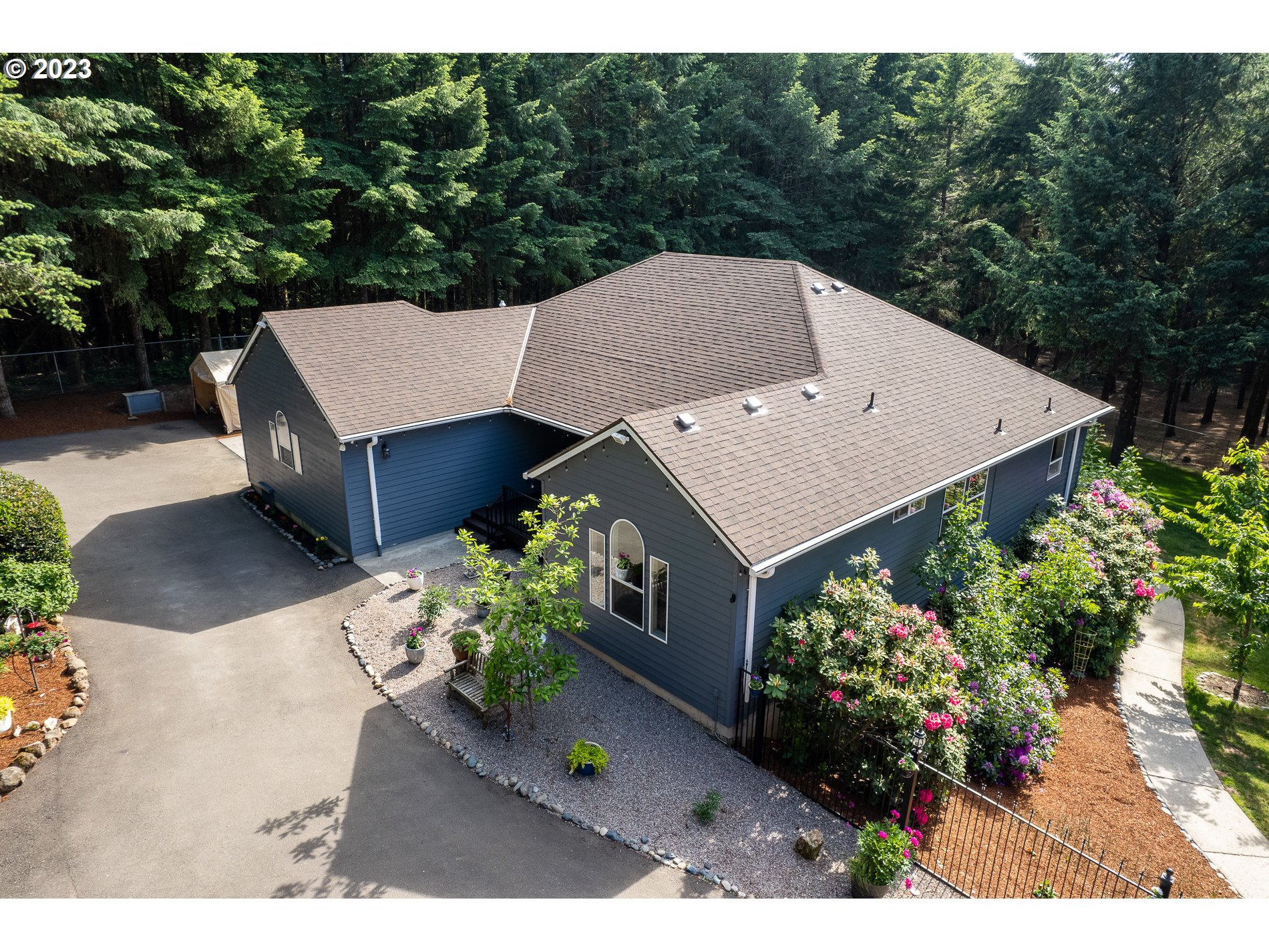 12133 Southeast Laughing Water Road Sandy, OR 97055 - Photo 2 of 47 an aerial view of a house with a yard and potted plants