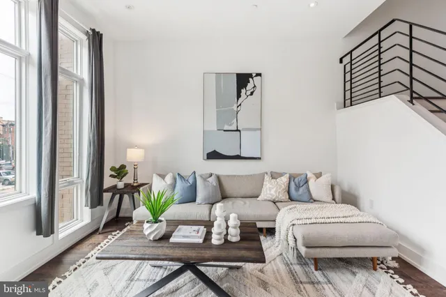 an empty room with wooden floor and a ceiling fan