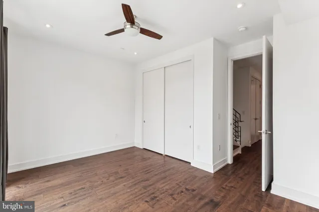 a bathroom with a sink vanity mirror and toilet