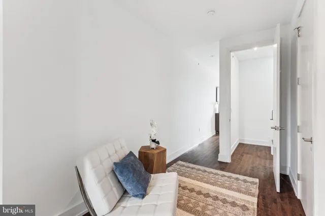 a bedroom with a bed and glass walk in closet