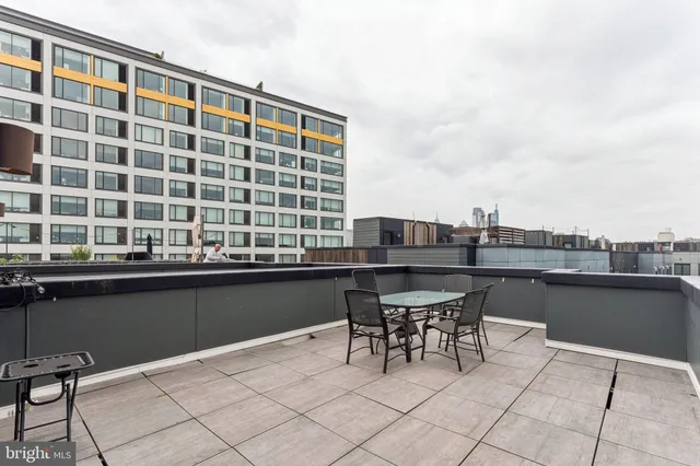 a front view of a building with sitting area